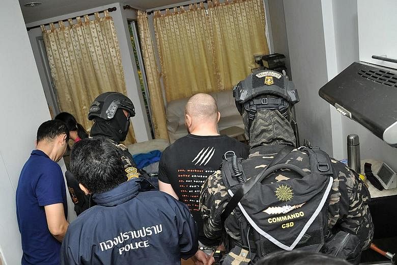 Thai police arresting Russian national Sergey Medvedev.