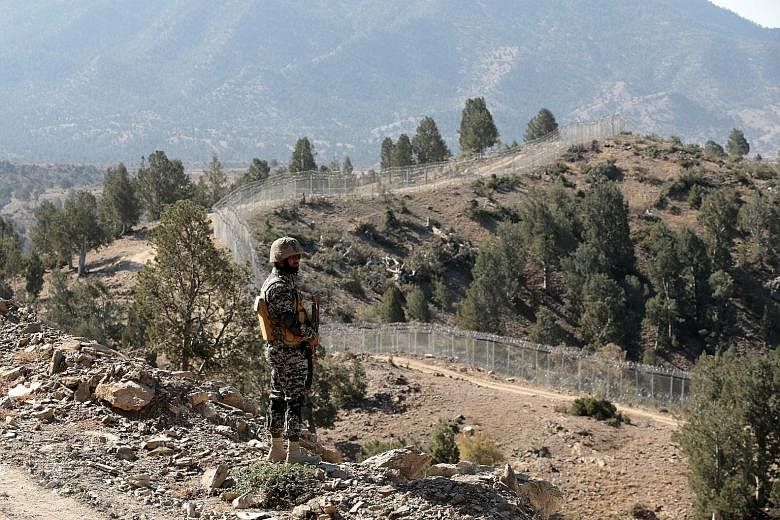 A Pakistani soldier on guard at the Angoor Adda outpost on the border with Afghanistan in South Waziristan. Pakistan is pushing for the completion of a fence along its disputed border with Afghanistan - and it wants the US to help pay for it.