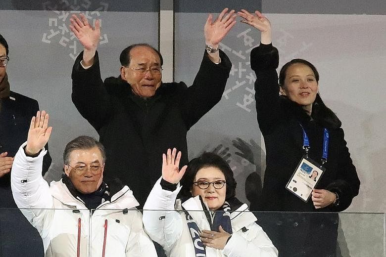 South Korean President Moon Jae In, his wife (both in front), North Korea's nominal head of state Kim Yong Nam and Ms Kim Yo Jong waving during the Winter Olympics opening ceremony in Pyeongchang, South Korea, yesterday. World leaders attended the op
