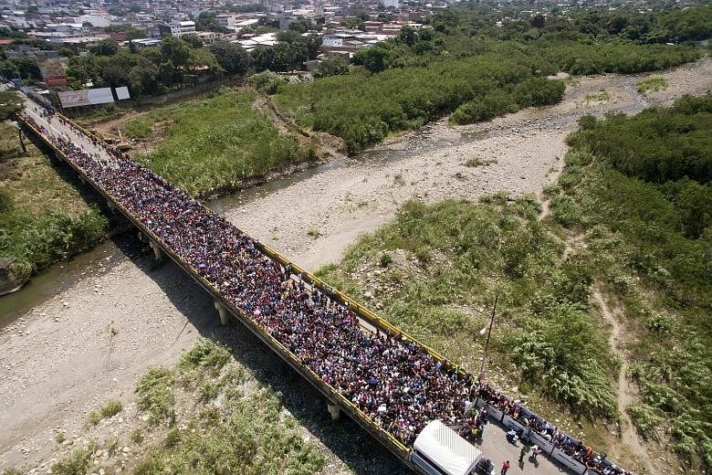 An aerial view of thousands of Venezuelans trying to enter Colombia through the border crossing of Cucuta on the Simon Bolivar International Bridge in Cucuta, Colombia, on Friday. Colombia and Brazil tightened border controls with Venezuela on Thursd