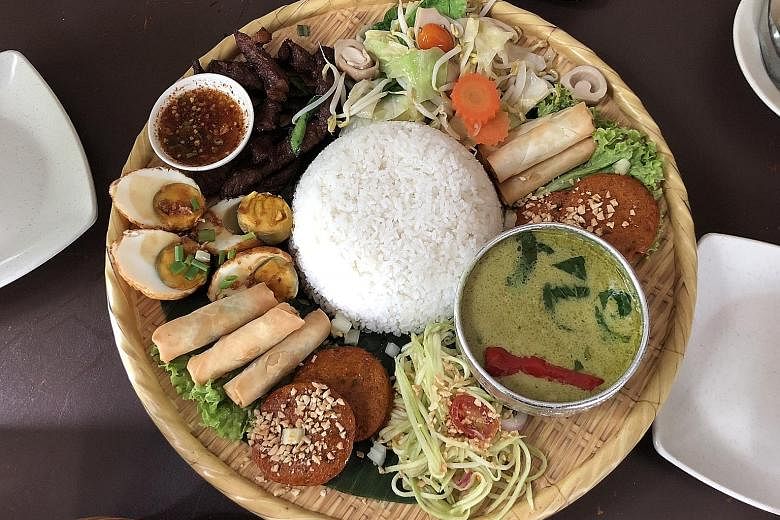 The Rice Platter has green curry with chicken, mango salad, vegetables, beef, spring rolls, fish cakes and eggs.