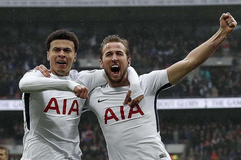 Tottenham Hotspur's England striker Harry Kane (right) celebrates scoring the opening goal with Dele Alli in yesterday's match against Arsenal at Wembley. It turned out to be the only goal of the game.