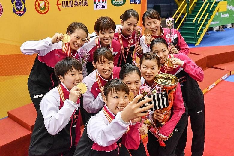 Nozomi Okuhara taking a wefie of the Japanese team after their 3-0 defeat of China in the Badminton Asia Team Championships final at Alor Setar, Malaysia, yesterday. Okuhara delivered the winning point, defeating He Bingjiao in three sets. There was 