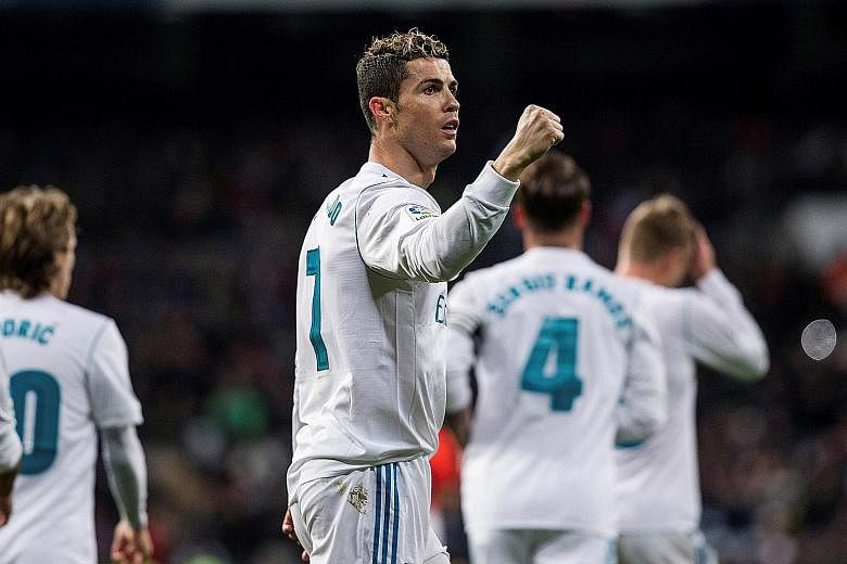 Real Madrid forward Cristiano Ronaldo celebrating the second goal of his hat-trick against Real Sociedad at the Bernabeu on Saturday. The Portuguese has been criticised this season for falling short of his usual prolific standards but, having notched