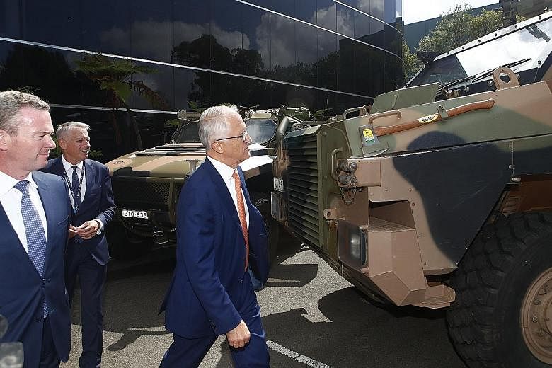 Australian Prime Minister Malcolm Turnbull inspecting the Bushmaster armoured vehicle during a visit to Thales Underwater Systems in New South Wales late last month. Mr Turnbull wants Australia to move into the top 10 in arms exports, up from its cur