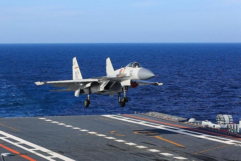 A J-15 fighter jet landing on the Chinese aircraft carrier Liaoning last year. China had more than 700 fourth-generation fighter jets last year, compared to 24 in 1996, the US-based Rand Corporation estimates.