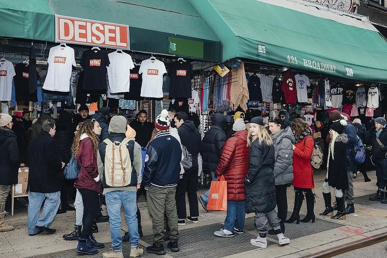 Shoppers at a faux Diesel pop-up shop in Canal Street in New York waiting to snap up clothes with an almost-right logo.
