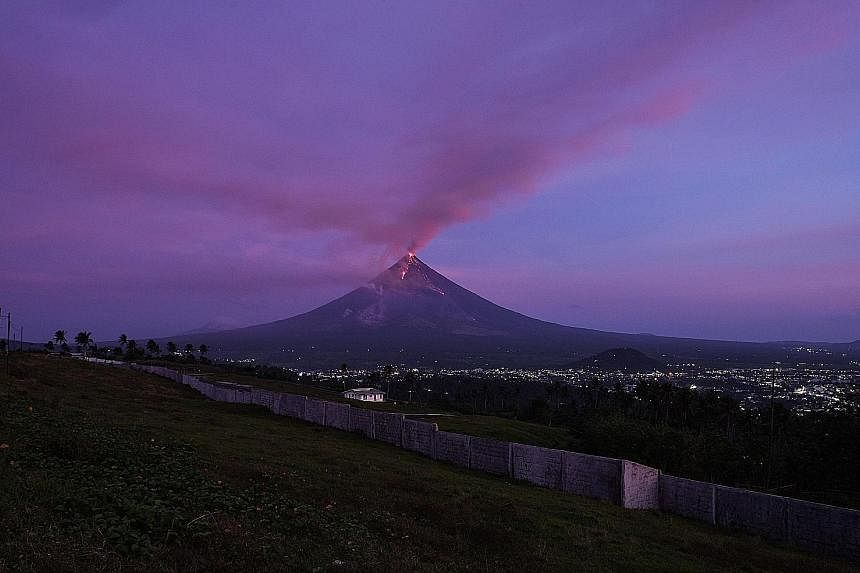 Mount Mayon spewing ash and lava from its crater during an eruption early on Jan 30. The volcano started erupting on Jan 13 and has been generating giant cauliflower clouds of superheated ash rising as high as 4.8km and bursts of fireworks-like lava 
