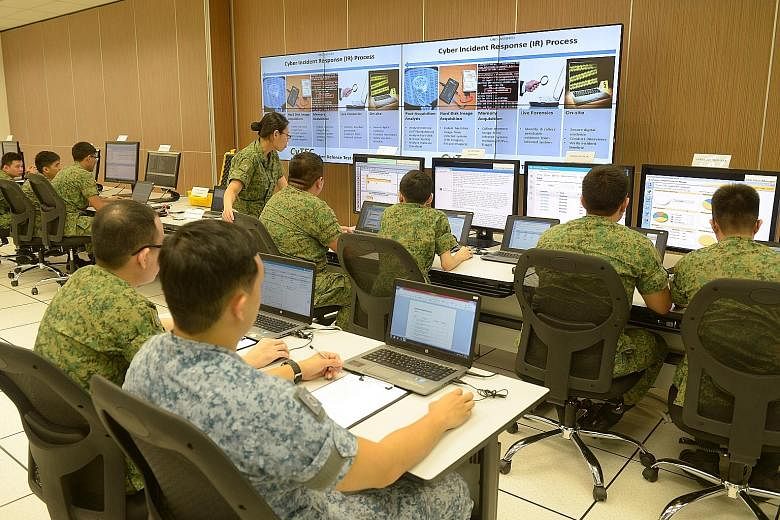 Soldiers at a demonstration showing how they would handle cyber threats at the Cyber Defence Test and Evaluation Centre in December last year. Mindef will start with 50 to 70 Cyber Specialist Awards for the first year.