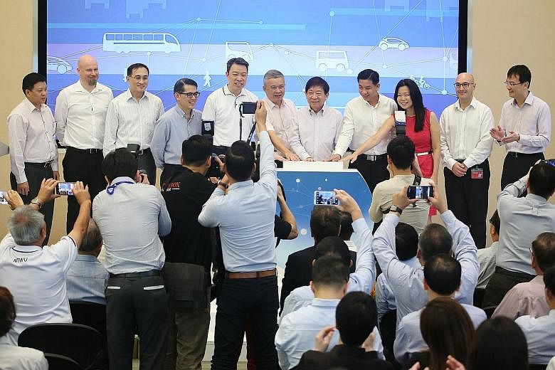 Transport Minister and Coordinating Minister for Infrastructure Khaw Boon Wan (seventh from left) and transport officials launching the Land Transport Industry Transformation Map yesterday at the PSA Building. They are (from left): Mr Yeo See Peng, S