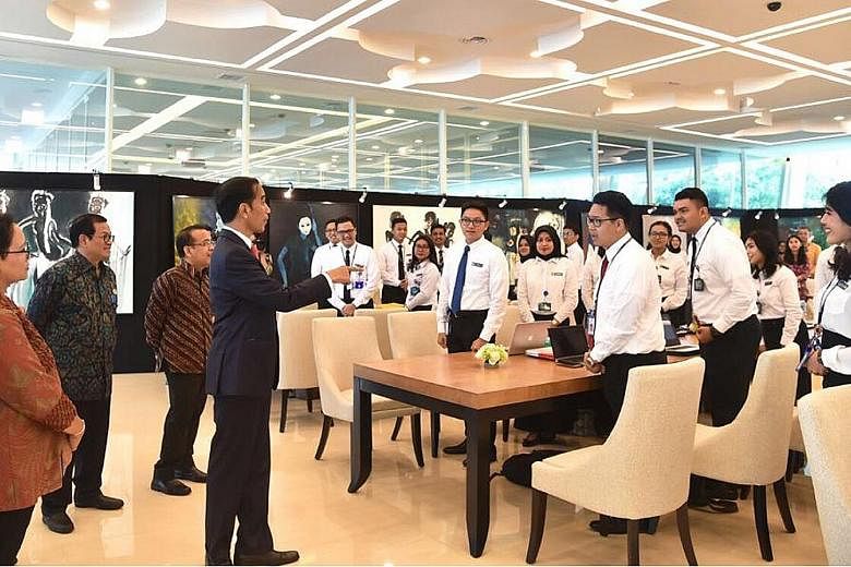 Indonesia's President Joko Widodo with (from left) Foreign Minister Retno Marsudi, Coordinating Security Minister Wiranto (partly hidden), Cabinet Secretary Pramono Anung and State Secretariat Minister Pratikno yesterday urged his diplomats to do mor