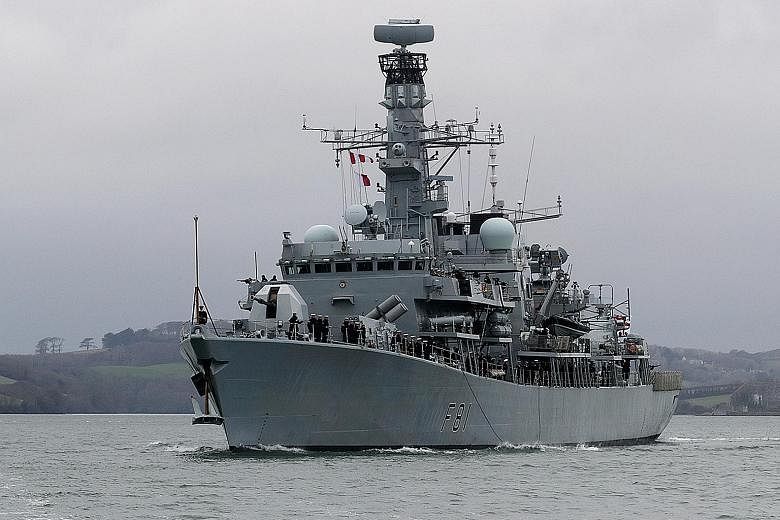 British Defence Secretary Gavin Williamson would not say whether HMS Sutherland (left) would sail within 12 nautical miles of a disputed territory or an artificial island built by the Chinese.