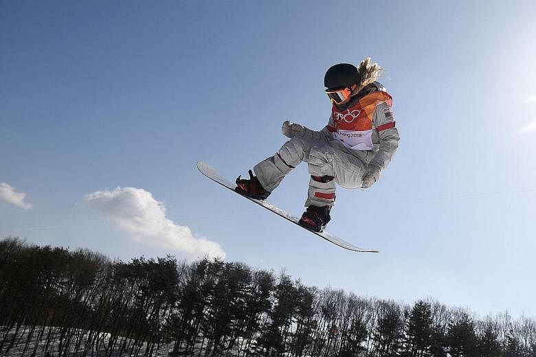 Chloe Kim performing a move during her third run yesterday in the snowboard half-pipe final at the Olympics, winning gold with a near-perfect 98.25. China's Liu Jiayu was second and American Arielle Gold third.