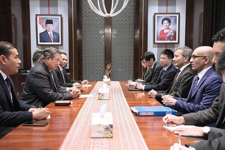 Foreign Minister Vivian Balakrishnan meeting former Indonesian president Susilo Bambang Yudhoyono (second from left) at his residence in Jakarta yesterday.