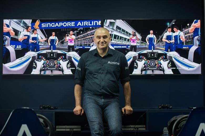 Serguei Beloussov with F1 simulators in the data storage and protection company's office. It is the first local firm to sponsor an F1 team.