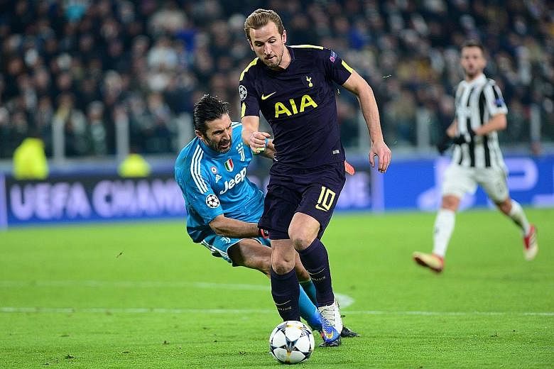 Tottenham's Harry Kane scores his first goal after evading Juventus' veteran goalkeeper Gianluigi Buffon. After conceding two goals in the first nine minutes of their Champions League encounter, Spurs fought back with goals from Kane and Christian Er