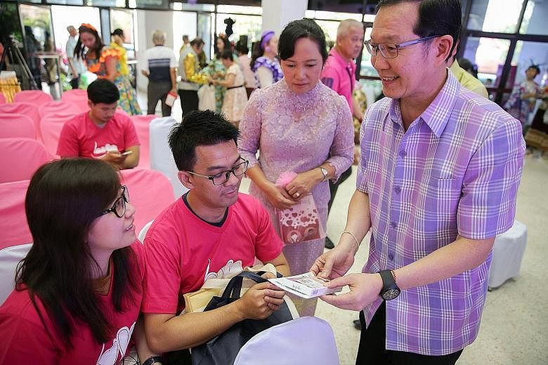 A public health officer giving vitamins to a couple at a Valentine's Day celebration in Bangkok yesterday. Thailand's cash bonuses and tax incentives for people with children have done little to boost births, but analysts said they were not generous 