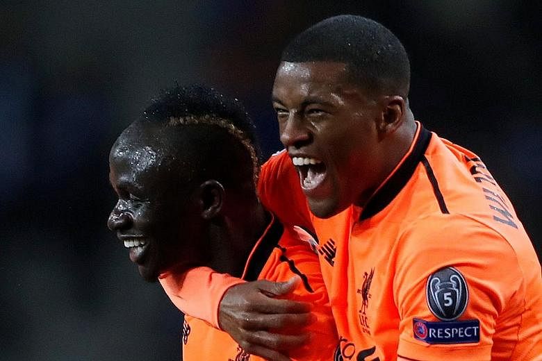 Georginio Wijnaldum (right) embraces Sadio Mane after the Senegal striker became the fourth Liverpool player to score a Champions League hat-trick, during the 5-0 first-leg win against Porto on Wednesday.