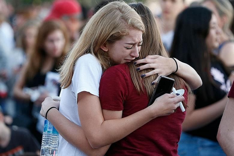 People visiting a temporary memorial in Parkland, Florida, last Friday, for the victims of the mass shooting at Marjory Stoneman Douglas High School that left 17 dead. Anger over the attack intensified after the FBI said that information it had recei