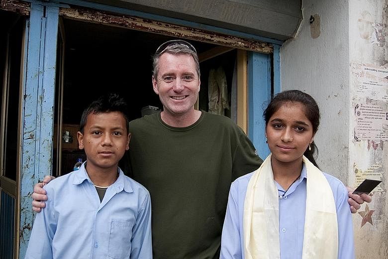 Mr Wood with students at the first library he built for a school in the village of Bahundanda in Nepal.