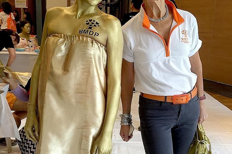 Ms Jane Prior with a Bone Marrow Donor Programme volunteer wearing body paint to turn herself into a human statue during a campaign on World Marrow Donor Day in 2016. Ms Prior announced in a Facebook post on Jan 29 that she is stepping down as chief 