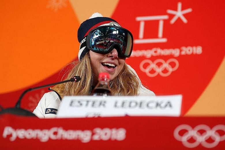 A joyous Ester Ledecka wearing ski goggles at a news conference, as she was not as prepared as the others "and I don't have no make-up". She was ranked only 43rd in the World Cup super-G standings.