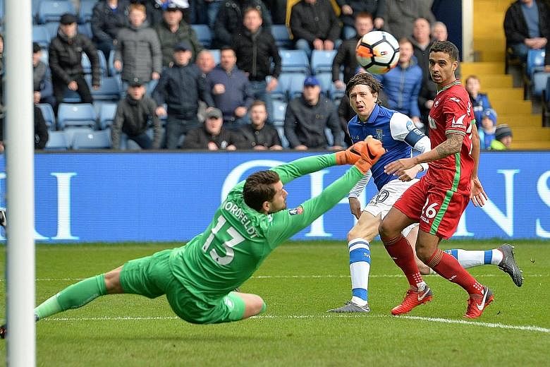 Swansea City's Kristoffer Nordfeldt saving a shot from Sheffield Wednesday's Adam Reach during yesterday's 0-0 draw in their FA Cup fifth-round clash at Hillsborough.