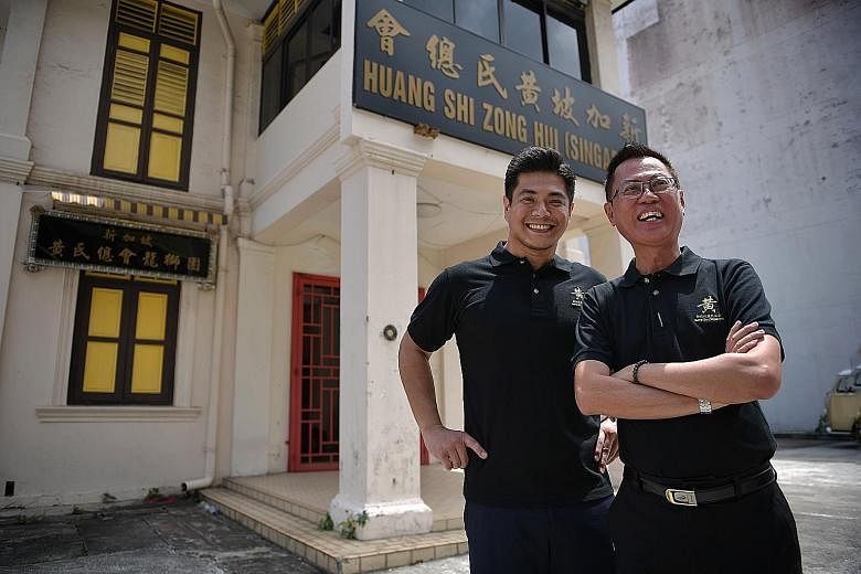 Huang Clan Association's youth committee secretary-general Stanley Ng (left), 32, with association vice-president Benny Ng, 63, on its Geylang premises. Mr Stanley Ng says that in recent years, he has been talking to elder clan members about the need