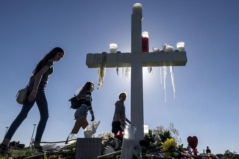 People visiting a temporary memorial in Parkland, Florida, last Friday, for the victims of the mass shooting at Marjory Stoneman Douglas High School that left 17 dead. Anger over the attack intensified after the FBI said that information it had recei
