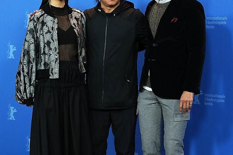South Korean director Kim Ki Duk (centre) with Japanese actress Mina Fujii and South Korean actor Lee Sung Jae, from his film Human, Space, Time And Human, in Berlin.