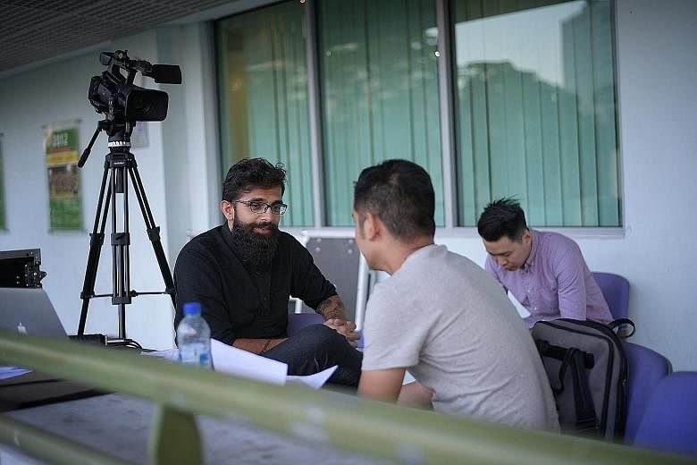 Farez Juraimi (right), a criminology student at the Singapore Institute of Technology, during his audition with FAS marketing manager Ravi Maan at the Jalan Besar Stadium last week. The FAS' plan is to assemble a pool of up to 20 announcers.