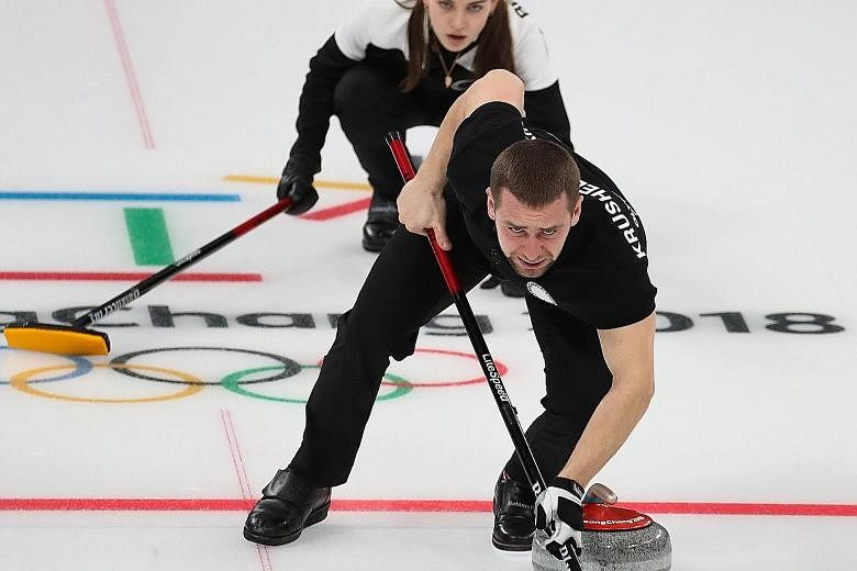 Alexander Krushelnitsky and his wife, Anastasia Bryzgalova, on their way to winning a curling bronze in the play-off against Norway on Feb 13.