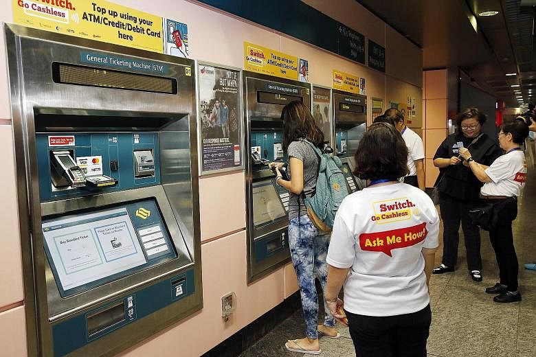 A service agent standing by to guide commuters in topping up their ez-link cards using ticketing machines at Hougang MRT station in September last year.