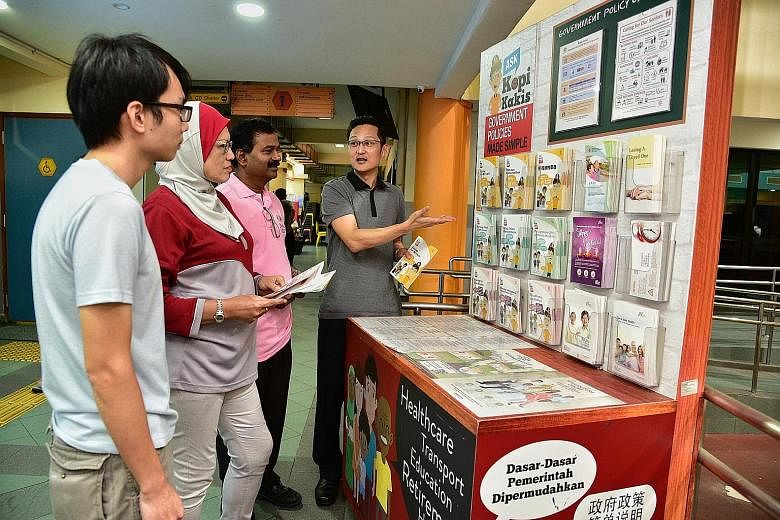 Mr Dennis Chee speaking to fellow workgroup members (from left) Andy Chan, Norazizah Mohd Tajudin and Perumal Moorthy about a PA initiative at Bukit Panjang Community Club.