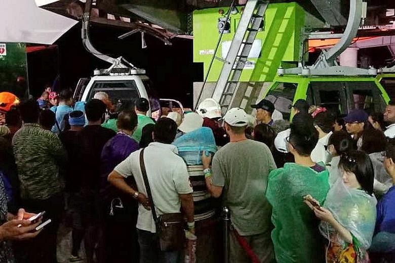 Tourists stranded on Gunung Machinchang lining up to get into the gondolas to take them down when the system was restored on Sunday night.