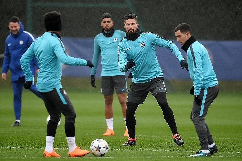 Chelsea striker Olivier Giroud (second from right) in training with team-mates including Emerson Palmieri (back) and Eden Hazard (right) ahead of today's Champions League last-16, first leg at Stamford Bridge. Blues manager Antonio Conte has a select
