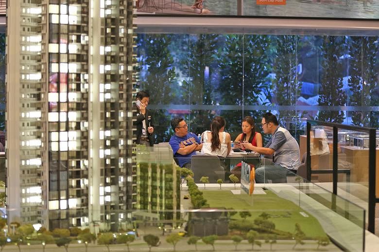 Potential buyers with housing agents at the Gem Residences showroom in Toa Payoh yesterday. The stamp duty change was announced at about 5.20pm, when most showflats were closing, catching many by surprise.