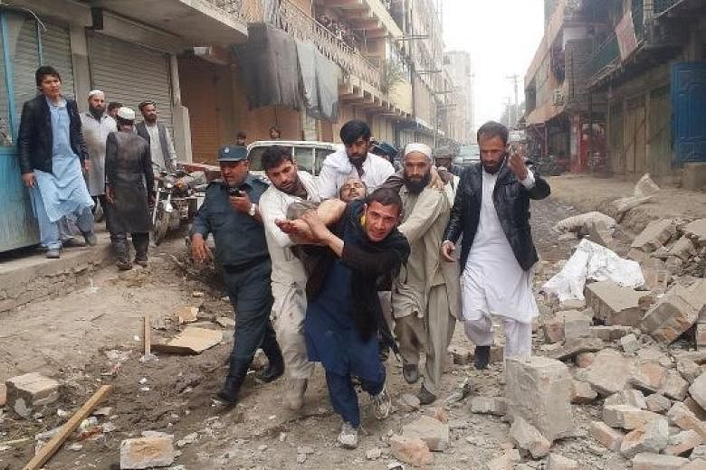 An injured man being carried away after the blast in Jalalabad yesterday. The explosion, which killed at least three tribal elders and wounded two, went off on the second floor of a hotel where the tribal elders were staying. The cause of the blast w