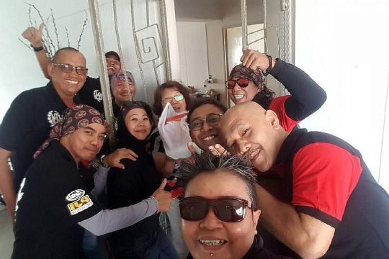 Volunteers, including biker group members, with a resident in Woodlands on the first day of Chinese New Year last Friday. They distributed packs of food mainly to elderly Chinese living alone, as well as those who are less mobile, but there were also