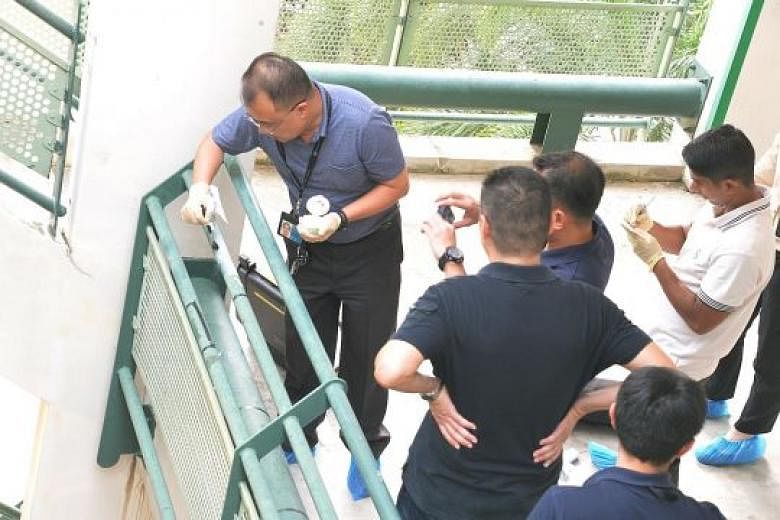 Police investigators collecting evidence at the multistorey carpark at Block 146A in Toa Payoh Lorong 2, after the body of Ms Atika Dolkifli, 23, was found. Syed Maffi Hasan, 27, is alleged to have thrown Ms Atika over the parapet at Deck 5A of the b