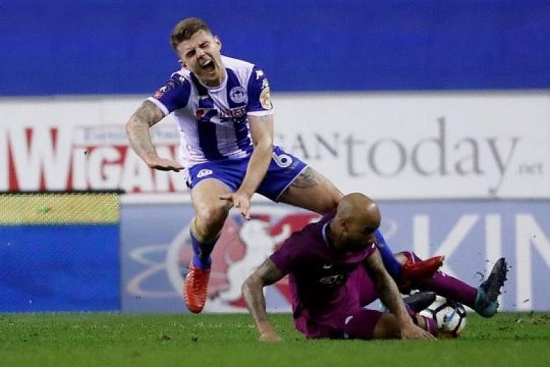 Manchester City's Fabian Delph leaving his studs up as he challenges Wigan's Max Power for a loose ball. Referee Anthony Taylor deemed it worthy of a red card, leaving the Premier League leaders to play out the entire second half with 10 men. 
