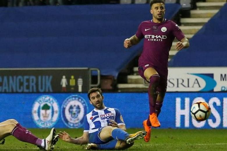 Wigan's Will Grigg scoring the game's only goal after a mistake by Manchester City's Kyle Walker.
