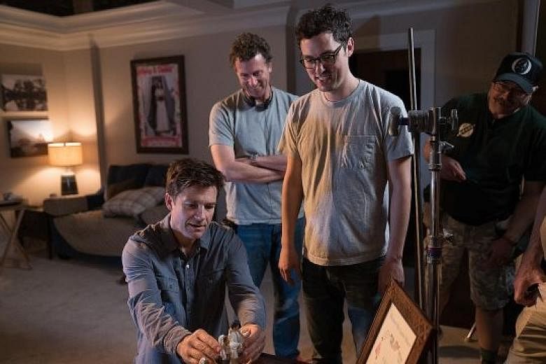 (From left) Actor Jason Bateman on the set of Game Night, which is directed by Jonathan Goldstein and John Francis Daley. With them is a crew member.