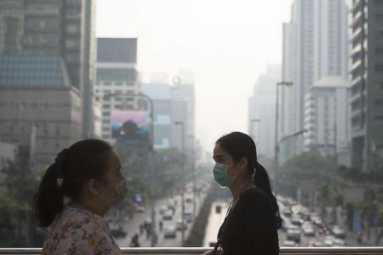 People with face masks to protect themselves against pollution in Bangkok. But some US researchers have found that paints and perfumes made up a bigger share of emissions as vehicles became cleaner.