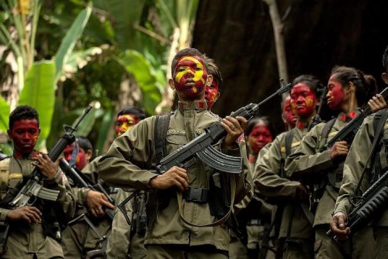 Guerillas of the New People's Army - the communist party's armed wing - in formation in the Sierra Madre mountain range, east of Manila, last year.