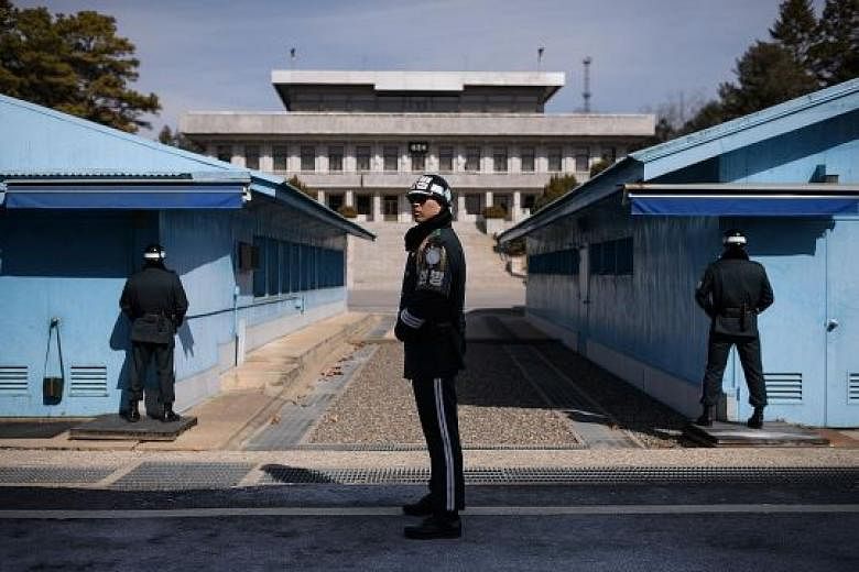 A South Korean soldier on guard before the military demarcation line and North Korea, in the truce village of Panmunjom, within the Demilitarised Zone dividing the two Koreas.