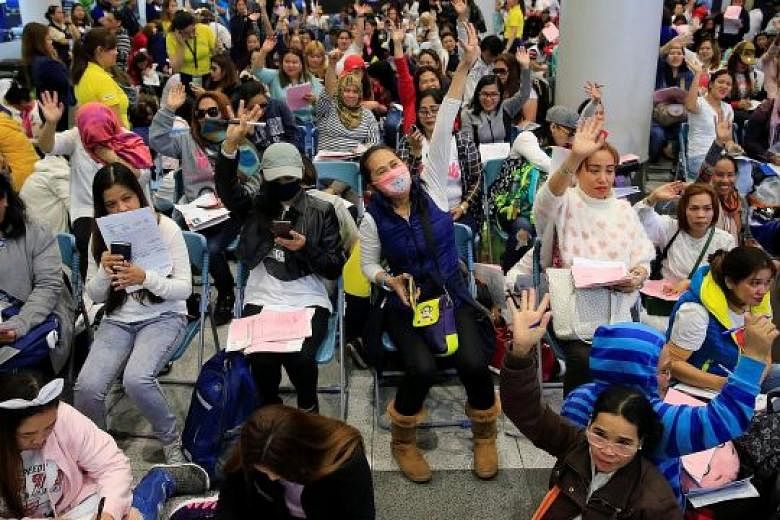Filipinos working in Kuwait arriving at Ninoy Aquino International Airport in Manila yesterday, following President Rodrigo Duterte's call to evacuate workers after the body of a Filipino domestic maid was found stuffed inside a freezer in the Gulf s
