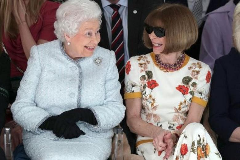 Queen Elizabeth with Vogue's Anna Wintour at the front row of London Fashion Week on Tuesday before presenting designer Richard Quinn with the inaugural Elizabeth II Fashion Award.