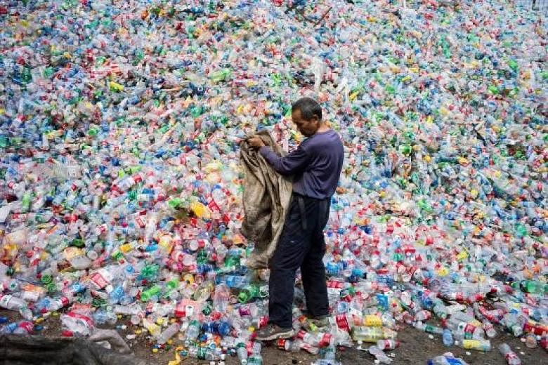 A Chinese worker sorting out bottles for recycling. China, the world's biggest importer of waste, is curbing its waste intake.