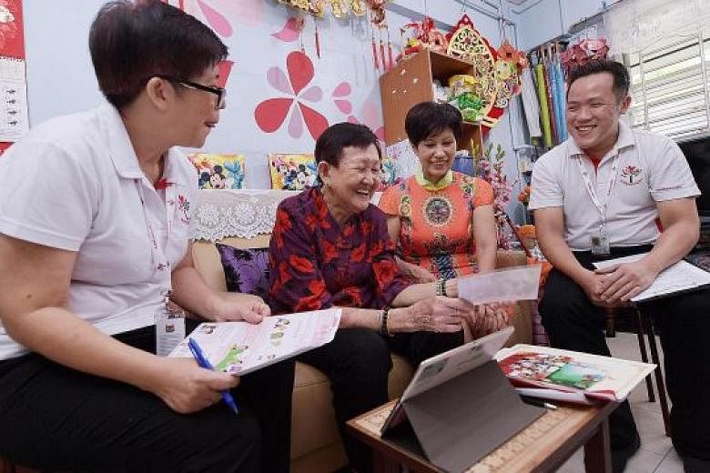 Ms Indranee Rajah chatting with Madam Chua Lye Suan, 77, during a visit to her home in Teck Whye Lane yesterday. With them were Pioneer Generation Ambassadors Audrey Goh, 58, and Alex Goh, 34. SEE EDITORIAL A24
